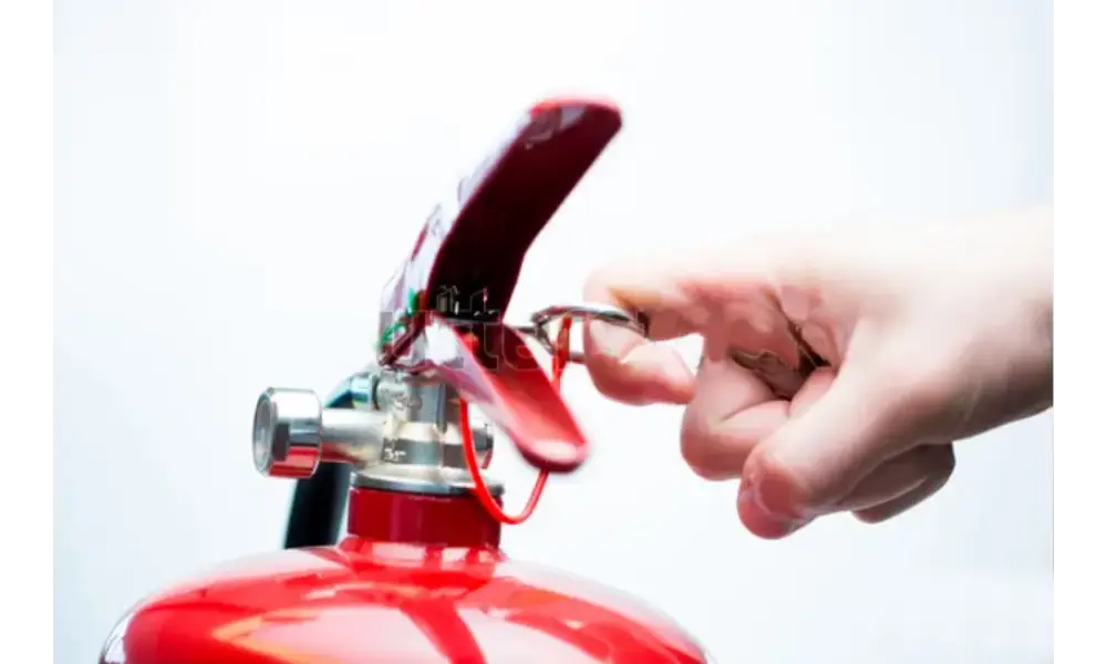 Someone servicing a Fire Extinguisher.